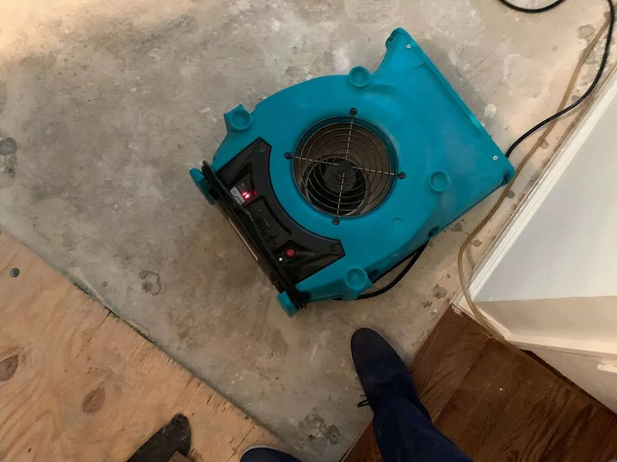 Air mover drying subfloor during Commercial Water Damage Restoration in Westerville